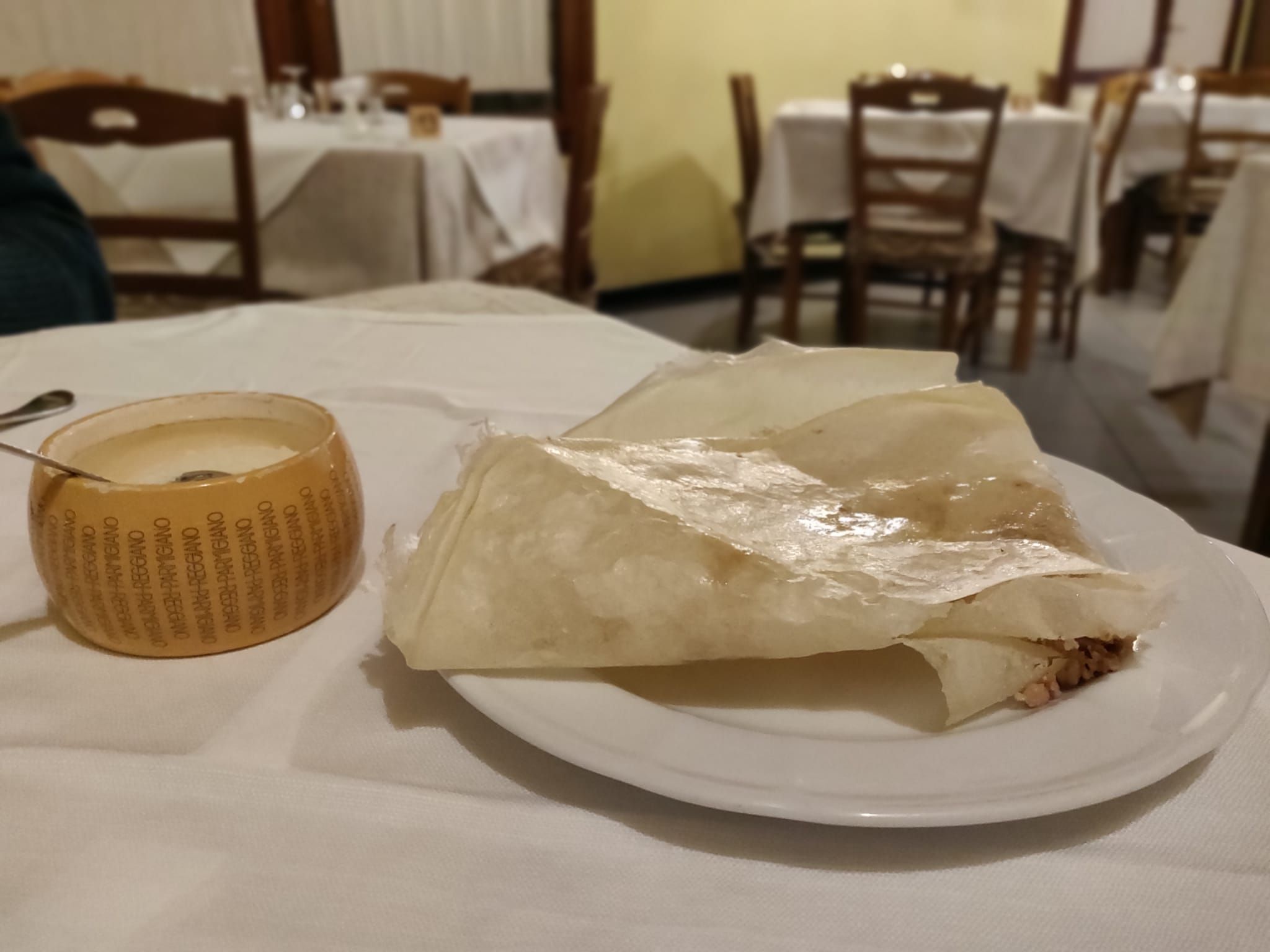 Borlengo modenese ripiegato e servito caldo con cunza e Parmigiano Reggiano, ristorante che fa borlenghi a Modena